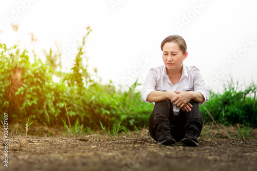 The disheartened and sad woman sit on the abandoned area.