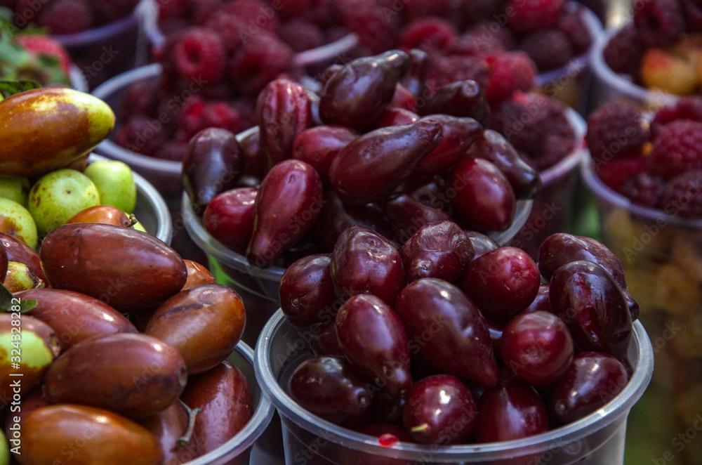Ripe fruits in glasses for street sale. Jujube, Red and white raspberries, figs, nuts. Travel and adventure. Ripe fruits in glasses for street sale. Jujube, Red and white raspberries, figs, nuts. Travel and adventure.
