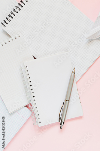 Top view of a flat lay of desktop and notepads for writing down goals and plans. 2020 New Year's goal, plan, action text on notepad with office accessories. Business motivation, inspiration concept.