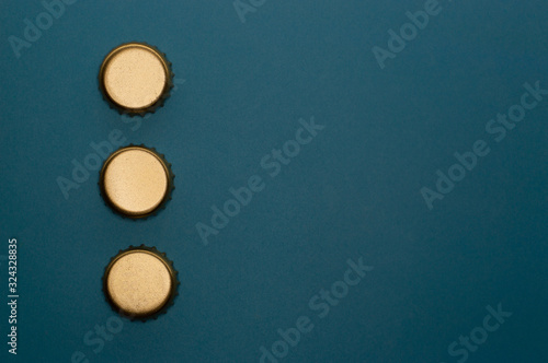 template of three bottle caps on blue background front