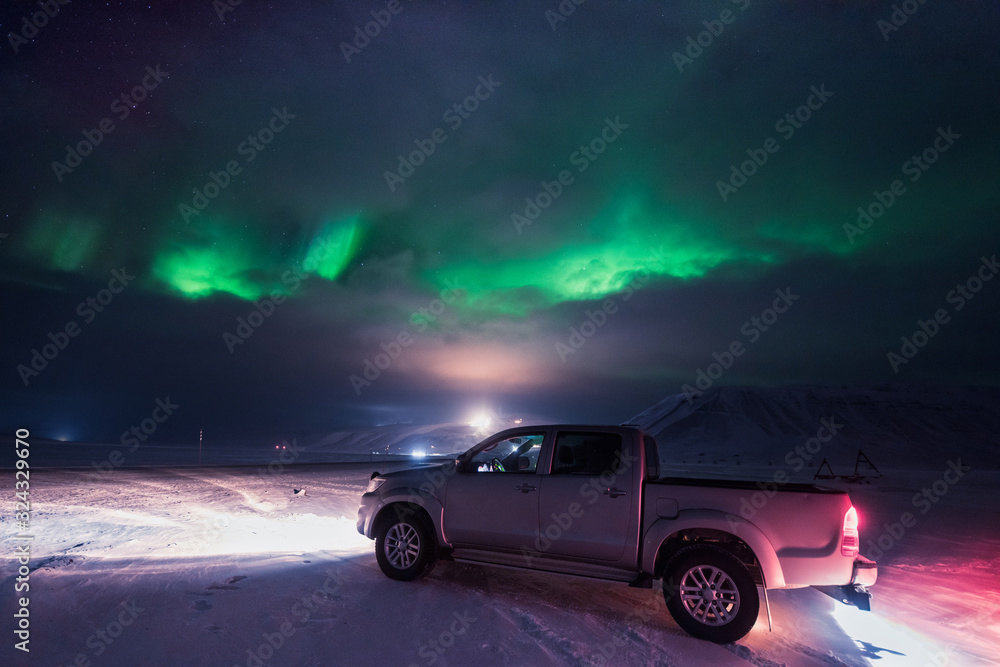 The polar arctic Northern lights hunting aurora borealis sky star in Norway travel photographer man Svalbard in Longyearbyen city the moon mountains