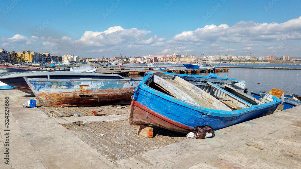 Overview with old fishing boats in the old city of Taranto, Puglia, Italy