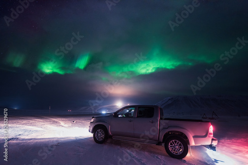 The polar arctic Northern lights hunting aurora borealis sky star in Norway travel photographer man Svalbard in Longyearbyen city the moon mountains