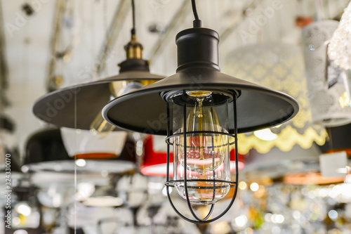 Close-up of a lamp in a man's hand. LED, luminescent, loft. © Dyachenko