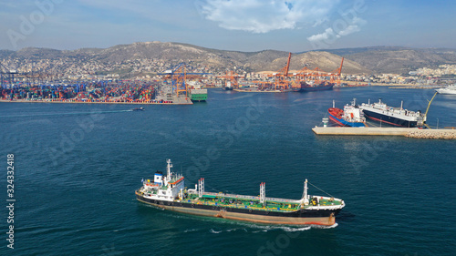 Aerial drone photo of industrial fuel ship cruising near commercial container area of Perama, Attica, Greece