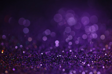 Purple glitter festive background. Abstract violet blurred circles. Bokeh lights with bright shiny effect illustration. Overlapping glowing and twinkling spots decorative backdrop design
