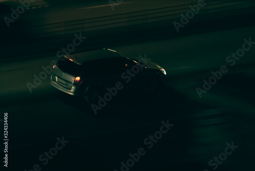 fast moving car on a dark night road. Speeding on the track. Overspeeding automobile with motion blur. Dangerous driving concept. probability of a traffic accident. ast and furious