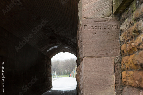 Flood level indicator next to footpath tunnel, River Trent, Trent Bridge, Nottingham, England, United Kingdom, UK. High tide, flooding risk