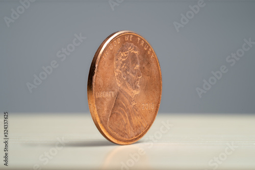 Money - Coins Lincoln Penny 2018 Angle View on wood with grey background