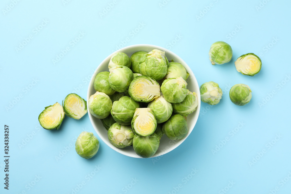 Bowl with brussels sprout on blue background, top view Bowl with brussels sprout on blue background, top view