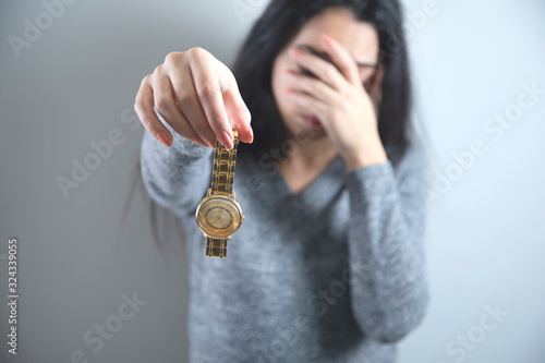 sad woman hand clock