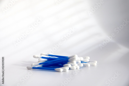 colorful blue cotton swabs on light background