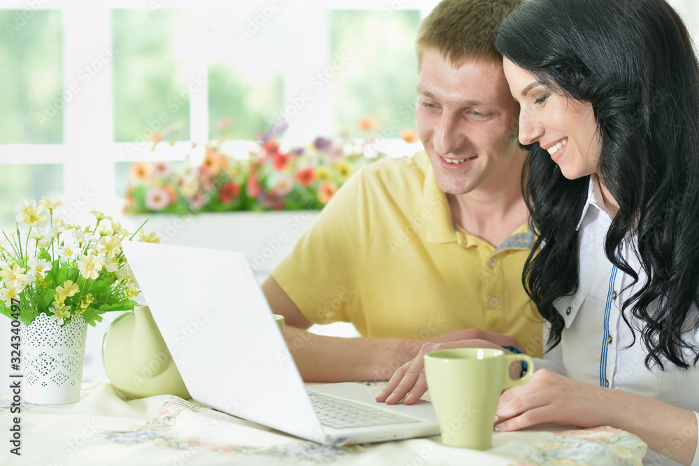 Portrait of happy young couple with laptop Portrait of happy young couple with laptop