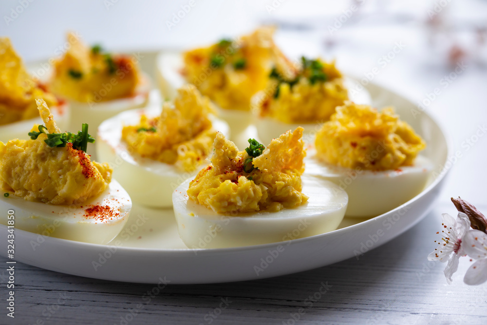 Devilled eggs canapes on the white plate