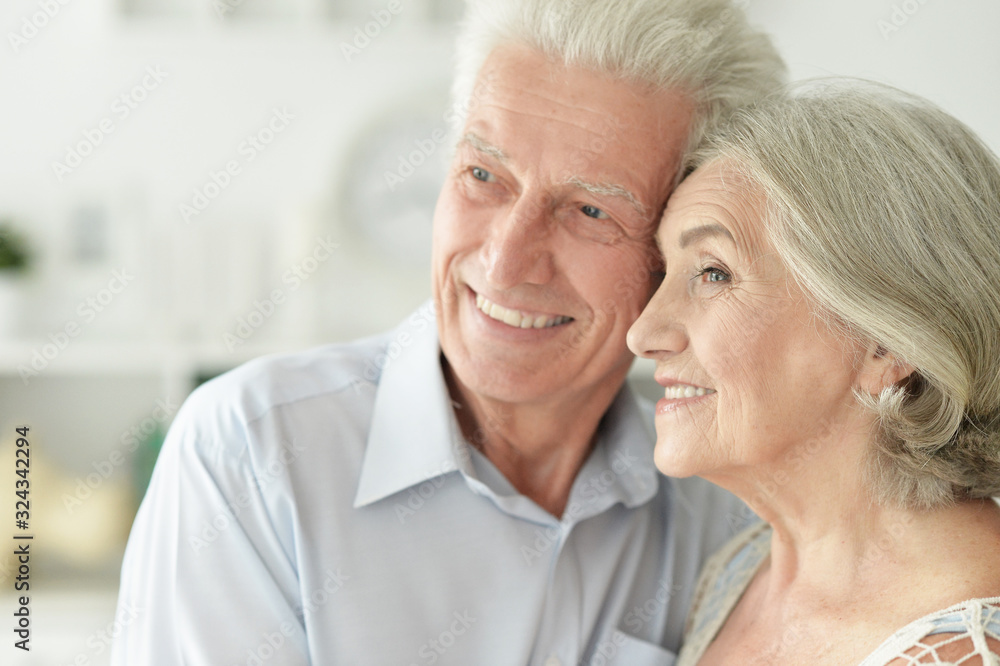 Portrait of cheerful senior couple embracing at home Portrait of cheerful senior couple embracing at home