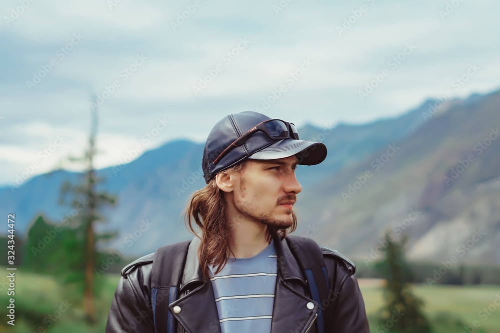 guy with a backpack near the mountains
