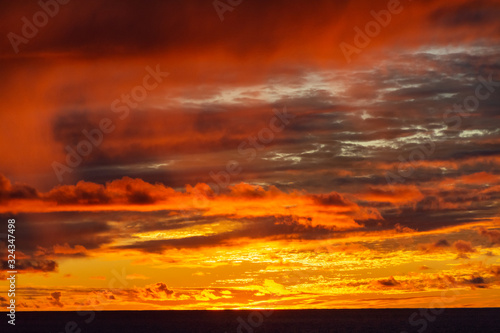 Fototapeta Naklejka Na Ścianę i Meble -  Amazing sunset with colorful clouds and dark ocean water, nature background
