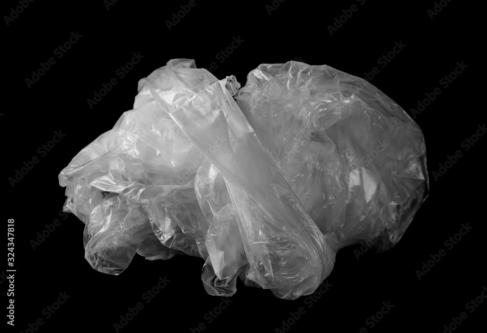 Crumpled white plastic bag isolated on black background 