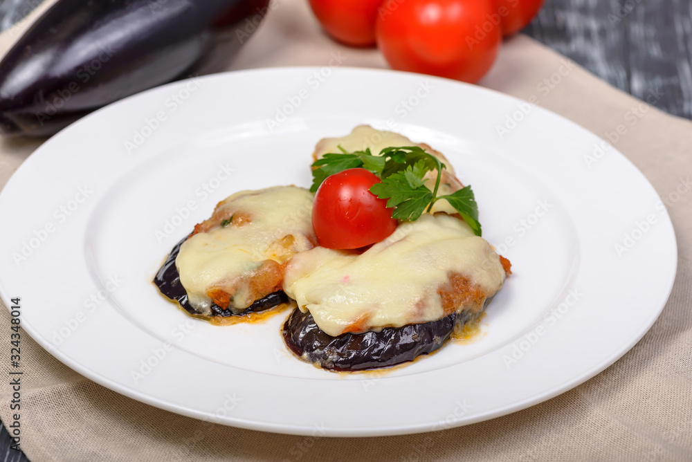 snack of grilled eggplant under cheese with tomatoes and herbs snack of grilled eggplant under cheese with tomatoes and herbs