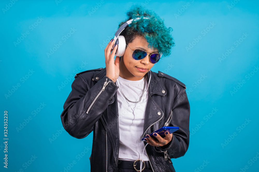 young brunette woman with trendy blue hair isolated on color background