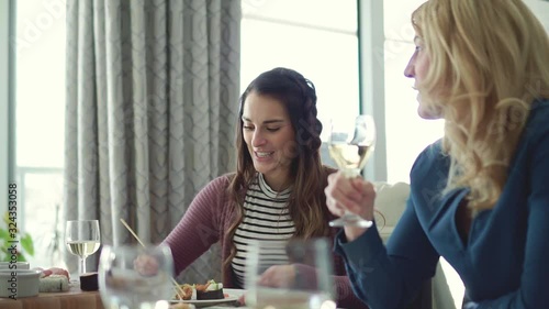 Group of attractive and funny woman eating sushi at home