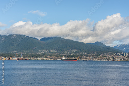 Vancouver, British Columbia, Canada - December, 2019 - Mountain View with clouds in a Beautiful blue sky day.