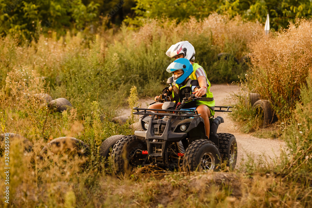 little boy with instructor on a quad bike little boy with instructor on a quad bike