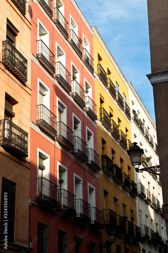 Fototapeta premium Yellow and orange houses with balconies, La Latina, Madrid, Spain
