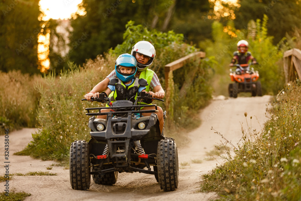 little boy with instructor on a quad bike little boy with instructor on a quad bike