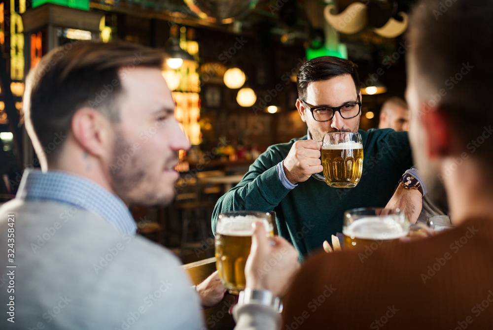 Group of happy friends in beer pub
