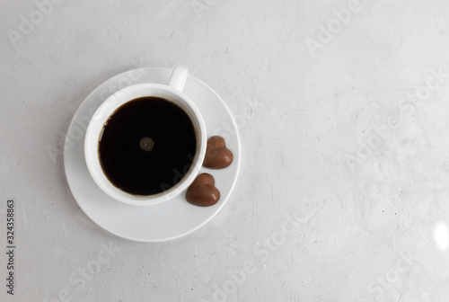 Black coffee in a white cup on a light background.