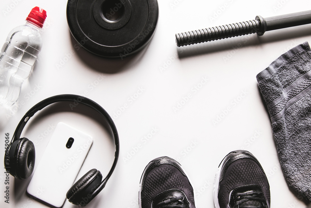 Towel, sneakers, and smartphone with headphones on a white background Towel, sneakers, and smartphone with headphones on a white background