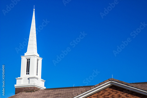 White Steeple Atop Small Church