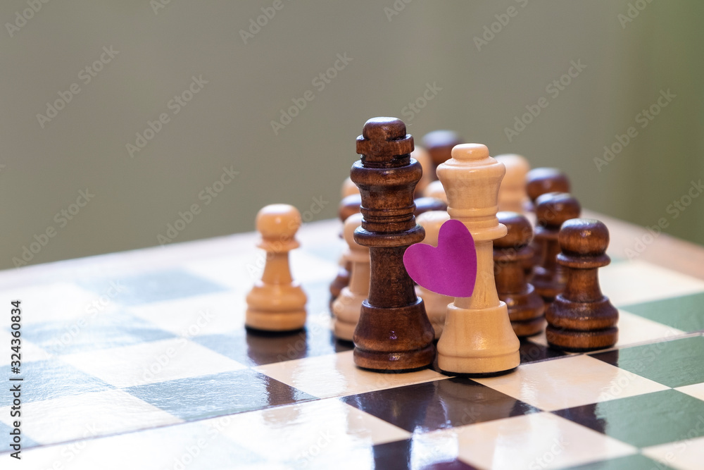 Love and racial prejudice. Chess pieces on a chessboard. Love and racial prejudice. Chess pieces on a chessboard.