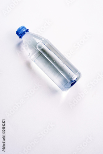 plastic bottle with a sparkle of water on a white background. Copyspace, place for text