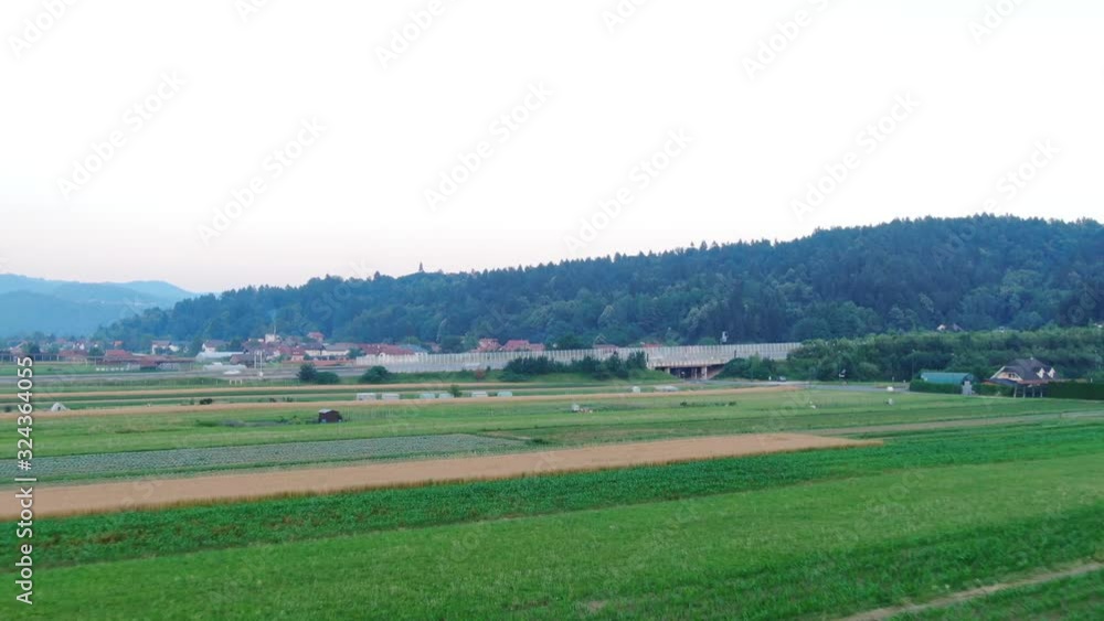 Flying under farms in Ljubljana, Slovenia, beautiful mountains in the background. Flying under farms in Ljubljana, Slovenia, beautiful mountains in the background.