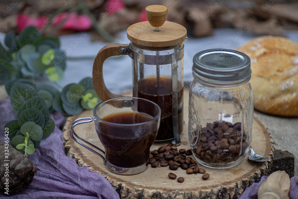 Coffee cup with brewing accessories on wooden board Coffee cup with brewing accessories on wooden board
