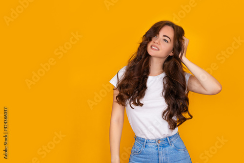 beautiful brunette girl on a yellow background