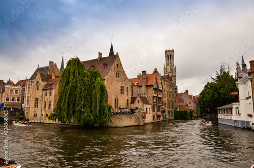 Bruges, flanders belgium.August 2019.Rozenhoedkaai is a landmark of the historic center, the most loved by tourists: the canal that curves around the house with the willow and the bell tower.