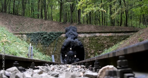 UDAPEST, HUNGARY - SEPT.28.2019: A steam train chugs through a tunnel in a mountainside