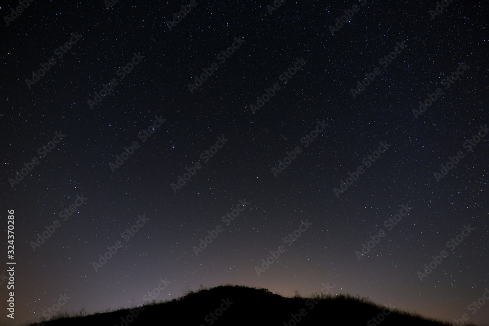 Bright stars of the night sky. Astrophotography with a long exposure.