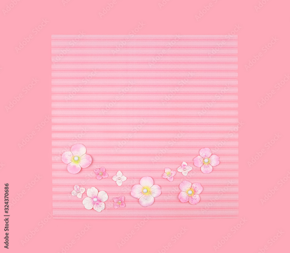 decor flowers on pink paper background. 8 march, mother's day greeting card. festive concept. copy space