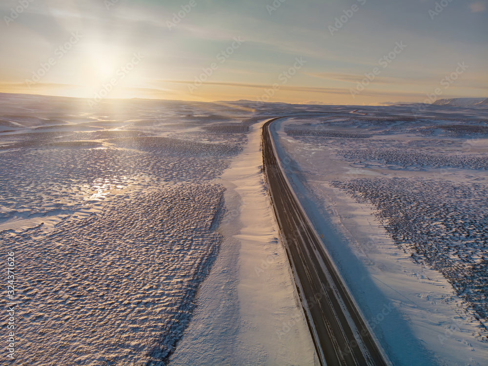 Straight road through the frozen landscape of Iceland 