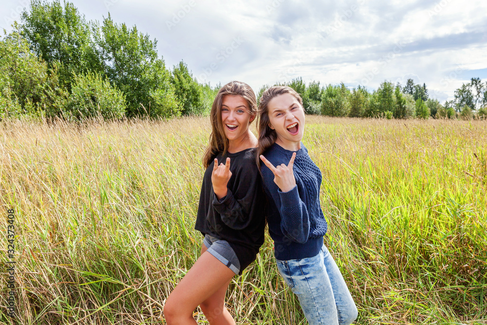 Summer holidays vacation happy people concept. Group of two girl friends dancing hugging and having fun together in nature outdoors. Lovely moments best friend. Summer holidays vacation happy people concept. Group of two girl friends dancing hugging and having fun together in nature outdoors. Lovely moments best friend.