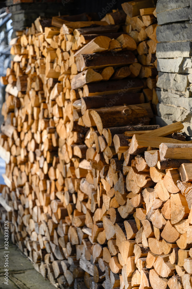 Log firewood stacked on top of each other. Log firewood stacked on top of each other.