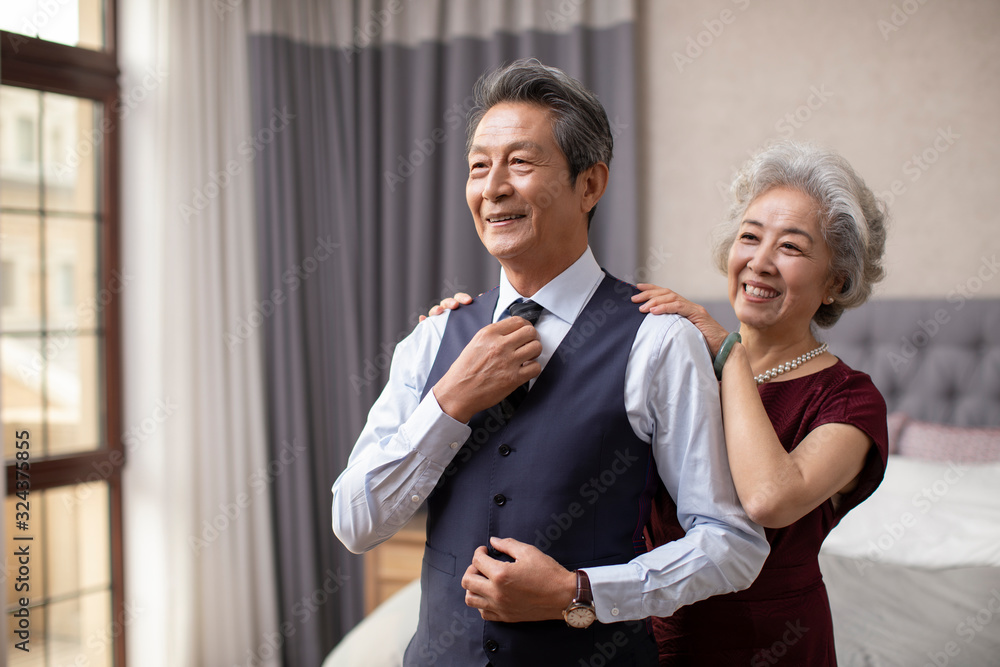 Happy senior Chinese couple getting dressed at home Happy senior Chinese couple getting dressed at home