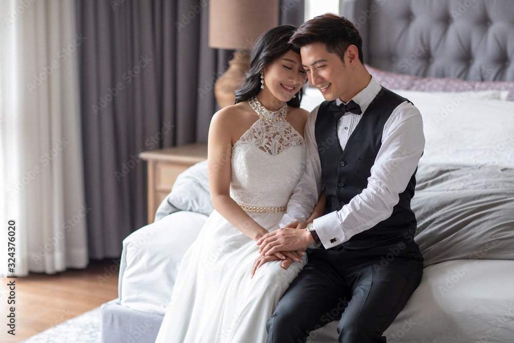 Happy young Chinese couple enjoying their love in bedroom Happy young Chinese couple enjoying their love in bedroom