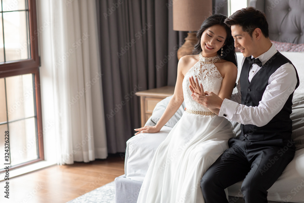 Happy young Chinese couple enjoying their love in bedroom Happy young Chinese couple enjoying their love in bedroom