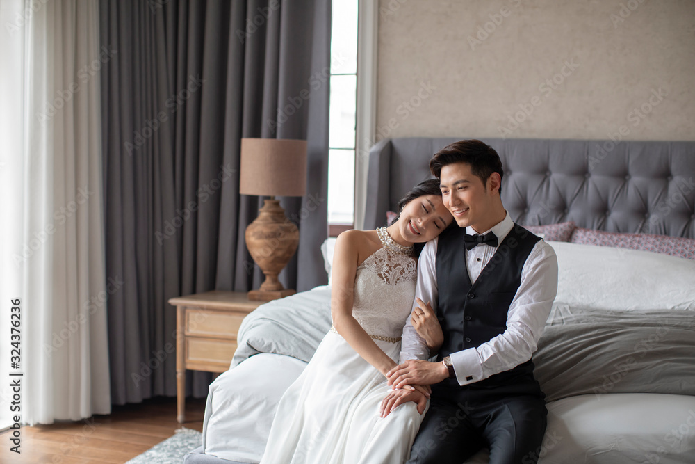 Happy young Chinese couple enjoying their love in bedroom Happy young Chinese couple enjoying their love in bedroom