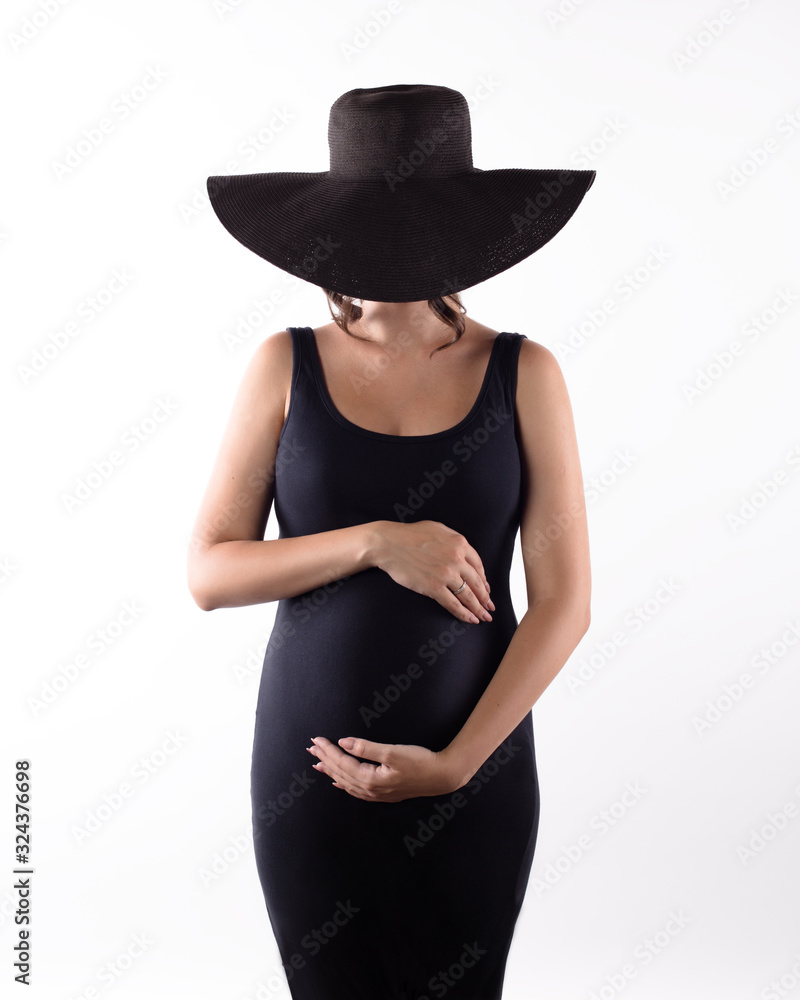 pregnant woman in black hat and dress on white background pregnant woman in black hat and dress on white background